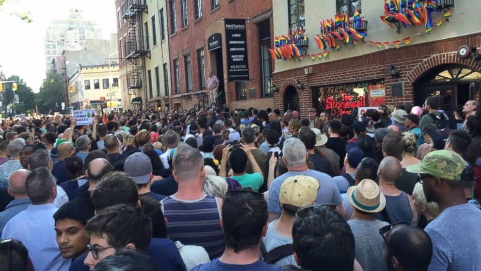PHOTO: People gather outside the Stonewall Inn in New York City to pay tribute to the victims of a mass shooting at a gay club in Orlando, June 12, 2016.