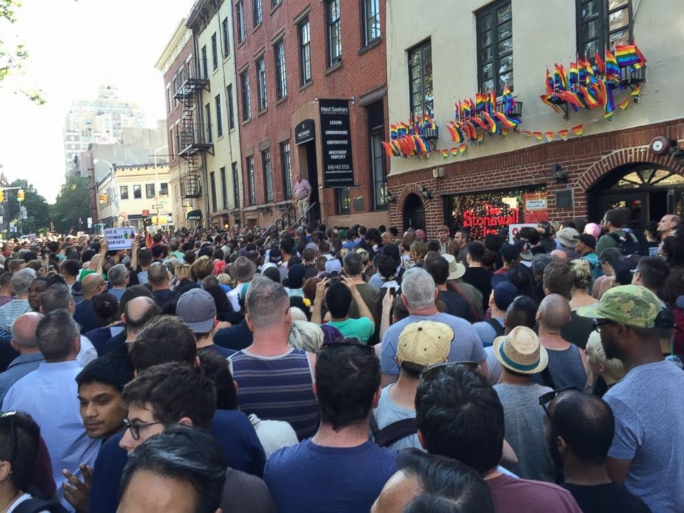 PHOTO: People gather outside the Stonewall Inn in New York City to pay tribute to the victims of a mass shooting at a gay club in Orlando, June 12, 2016.