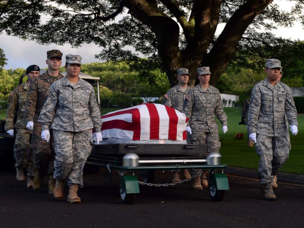 PHOTO: Members of the Defense POW/MIA Accounting Agency march alongside a disinterred casket holding the remains of unknown USS Oklahoma service members during a ceremony at the National Memorial Cemetery of the Pacific in Honolulu, Nov. 5, 2015. 