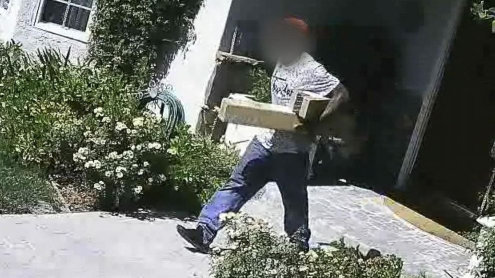 This image taken from surveillance video from homeowner Rick Deckman shows a man allegedly stealing packages. 