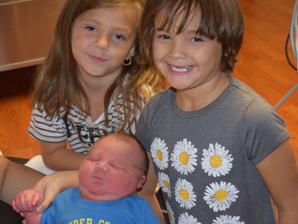 Baby Moses poses for the cameras with big sisters Elaura and Leghacy.