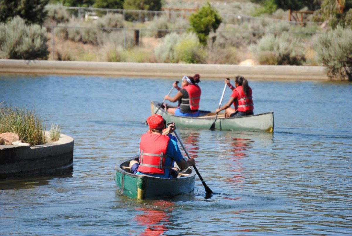 PHOTO: Campers on kayaks during the Camp To Belong summer camp.