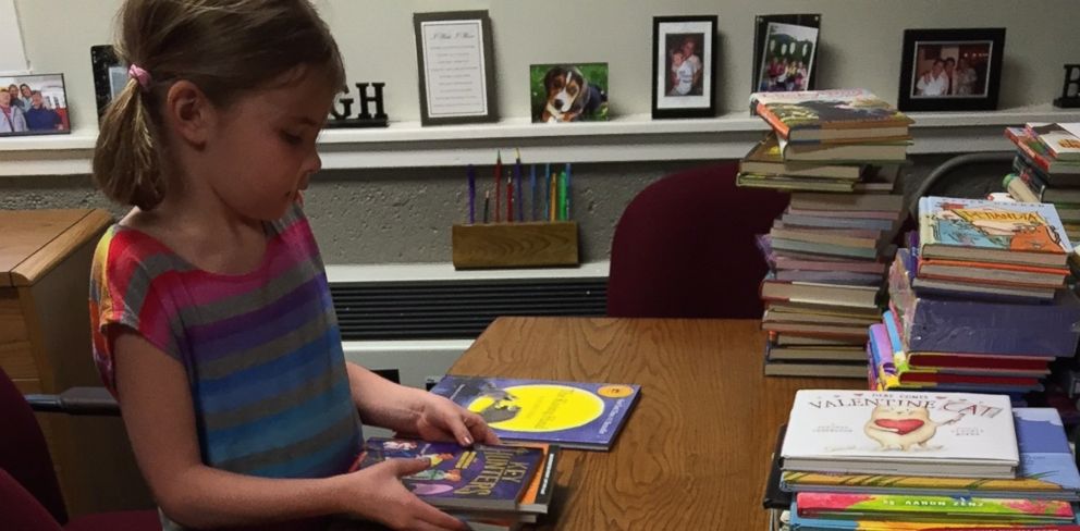 PHOTO:Heidi VanSumeren, 8, received hundreds of donated books after a fire at her Jackson, Michigan, home. 