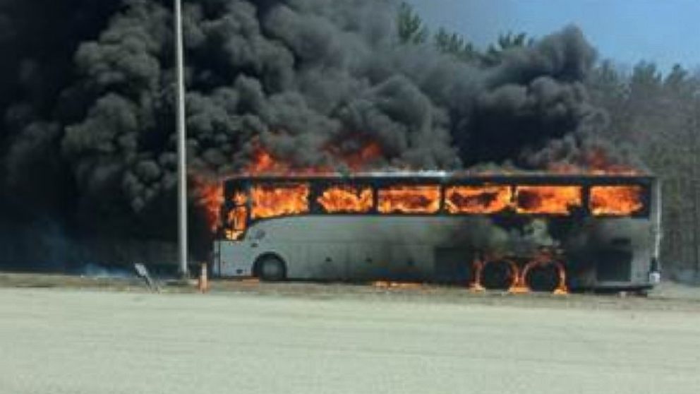 A bus fully engulfed in flames in Sturbridge, Massachusetts Saturday afternoon.