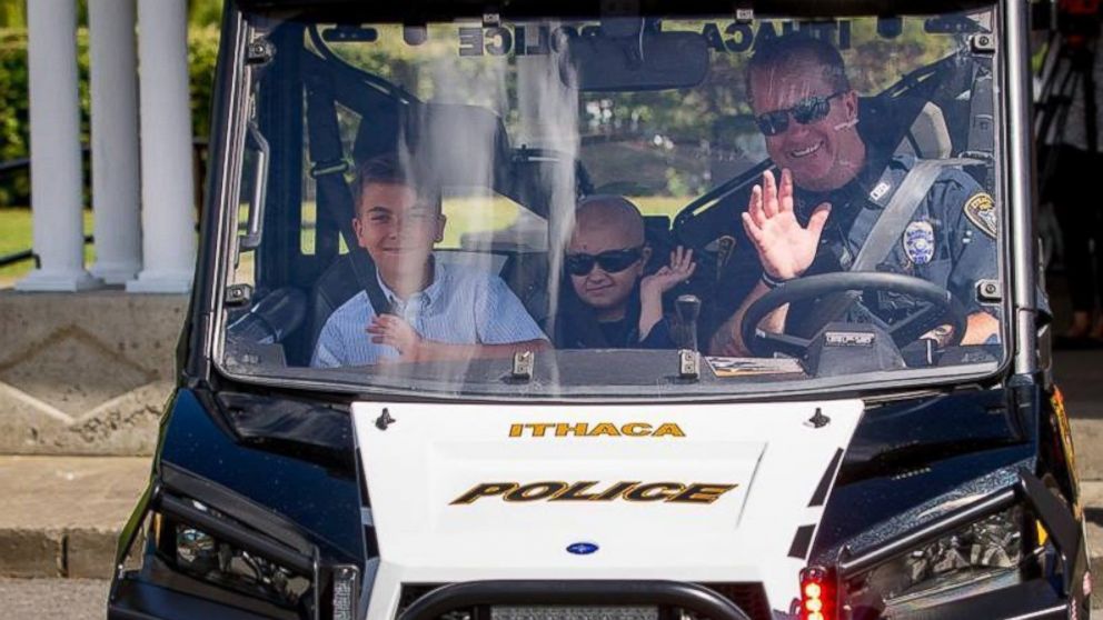 PHOTO: Colin Hayward Toland, 9, and his 12-year-old brother Aidan, ride in an Ithaca Police Department squad car the day it was sworn into the police force. 