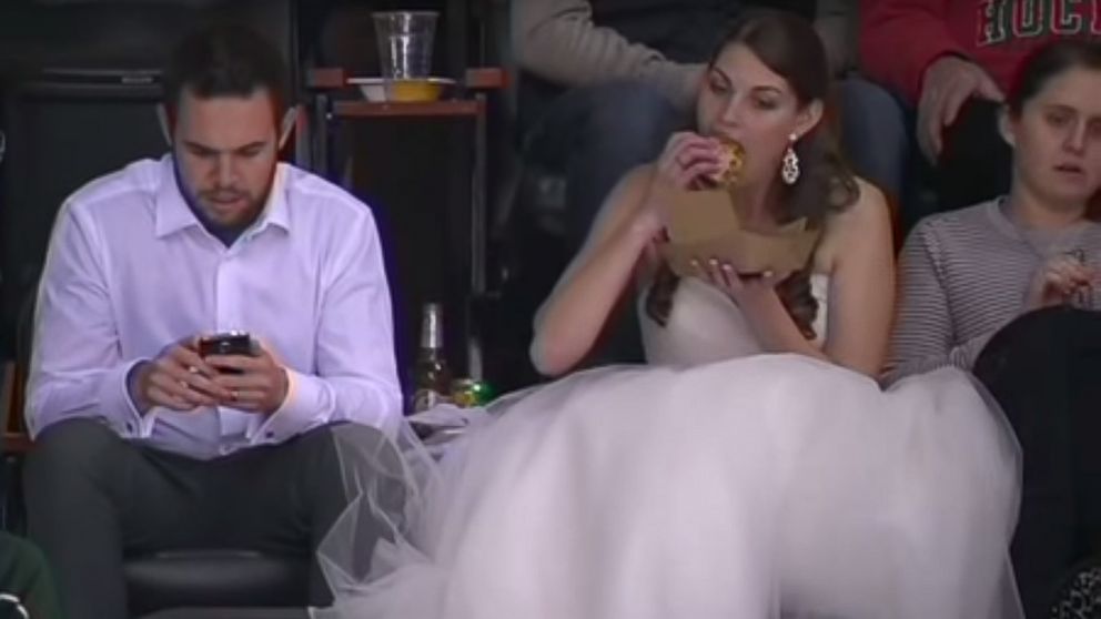 Newlywed Erika Skuta and Lewis Blake won hearts on the Internet after a video of Skuta eating a burger in her wedding dress at a Minnesota Wild hockey game posted on Nov. 29, 2015 went viral.  
