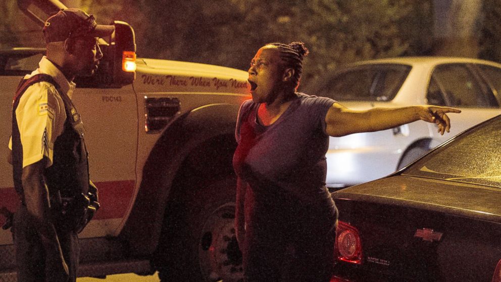 PHOTO: A woman talks to police near the scene where a man was shot in the leg near 87th and Morgan, in Chicago, July 6, 2014.