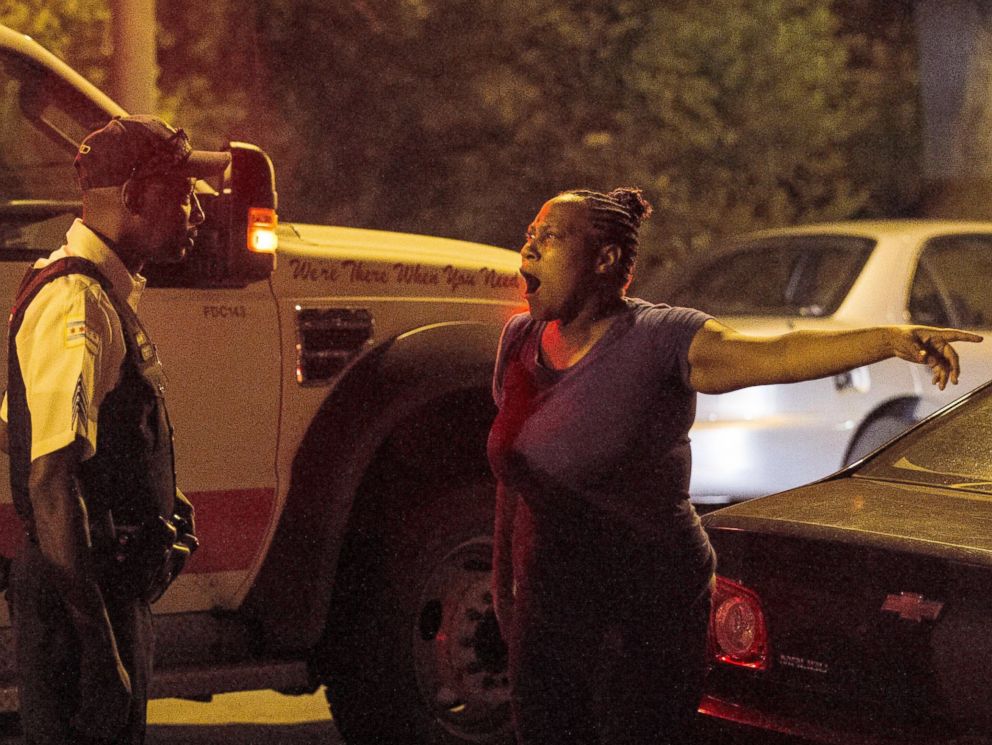 PHOTO: A woman talks to police near the scene where a man was shot in the leg near 87th and Morgan, in Chicago, July 6, 2014.