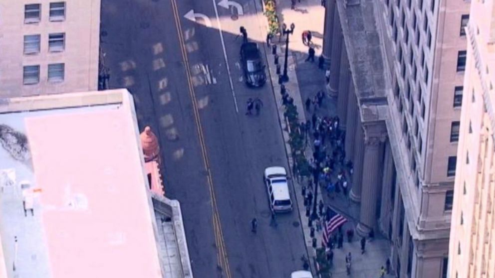 PHOTO: People gather outside 231 South Lasalle St. in Chicago following a shooting inside 