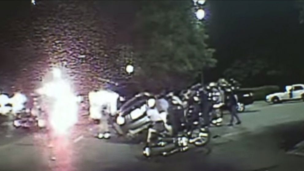 First responders and bystanders worked together to lift a car off a woman after a car crashed into her motorcycle on July 9, 2015 in Dallas, Texas.