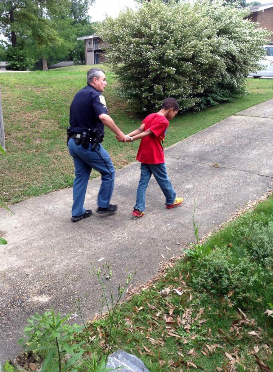 PHOTO: Sean, 10, is handcuffed by police outside his Columbus, Georgia home on April 28, 2015.