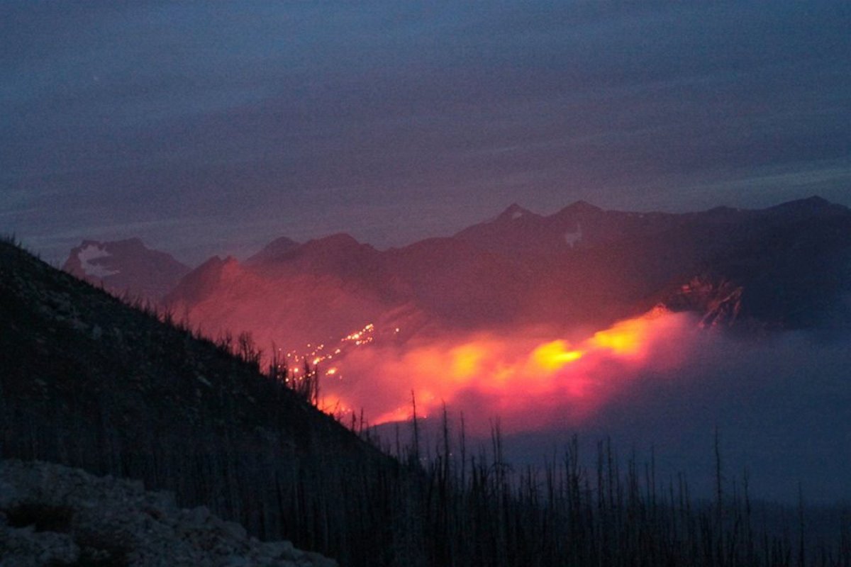 PHOTO: Fire and smoke rise above the landscape at Glacier National Park, Mont. 