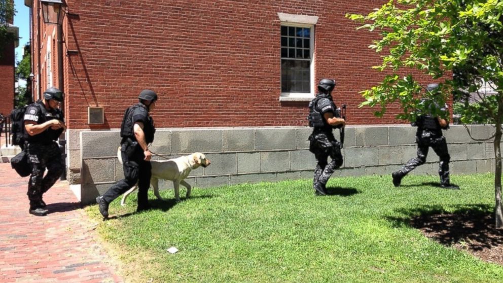 PHOTO: Local authorities leave Holworthy Hall in Harvard Yard after sweeping the building for potential bombs early Saturday afternoon.