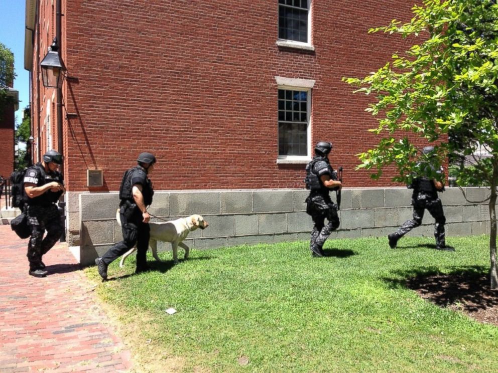 PHOTO: Local authorities leave Holworthy Hall in Harvard Yard after sweeping the building for potential bombs early Saturday afternoon.