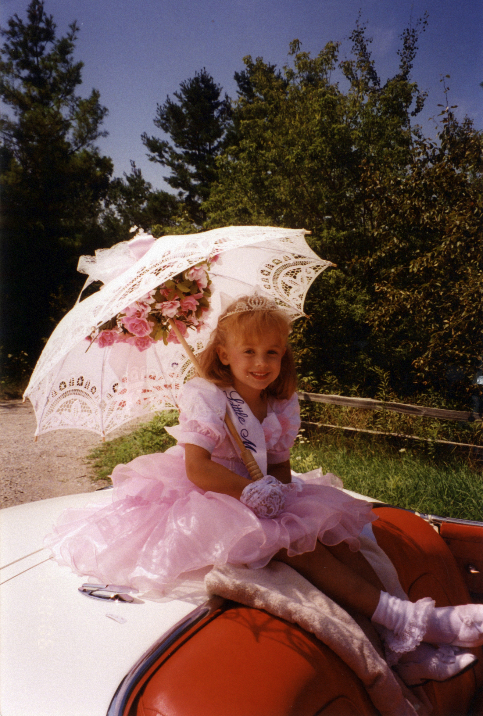 PHOTO: JonBenet Ramsey is pictured here in an undated photo riding on the back of a car for a local parade. She was found killed at age 6 in the family's basement in 1996.