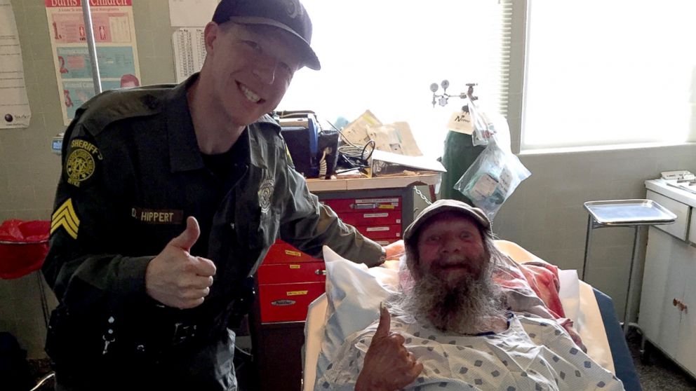 This photo provided by the Washoe County Sheriff's Office shows  Sgt. Dennis Hippert and Philip Besanson at a hospital in Cedarville, California.