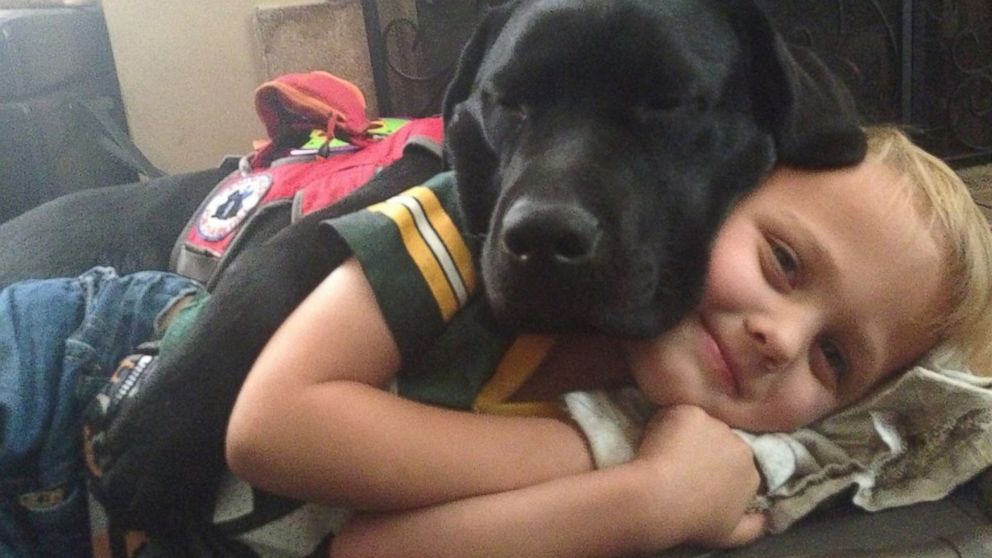Luke Nuttall, a 7-year-old boy from Glendale, California, is pictured here with his diabetic alert dog named Jedi.