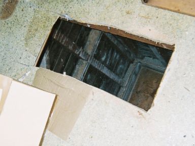 PHOTO: Kip and Nicole Macy cut this hole through the floor of their tenants apartment with a saw.