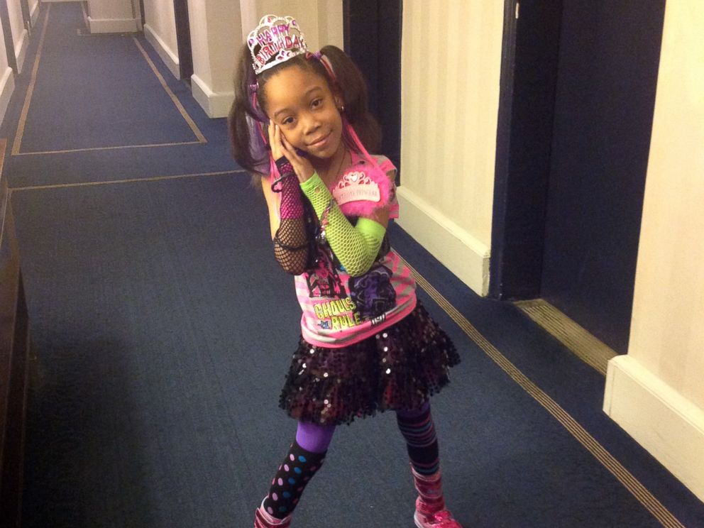 Najh’ja poses on her 7th birthday in the hallway of the Manhattan hotel where she has been living with her family.