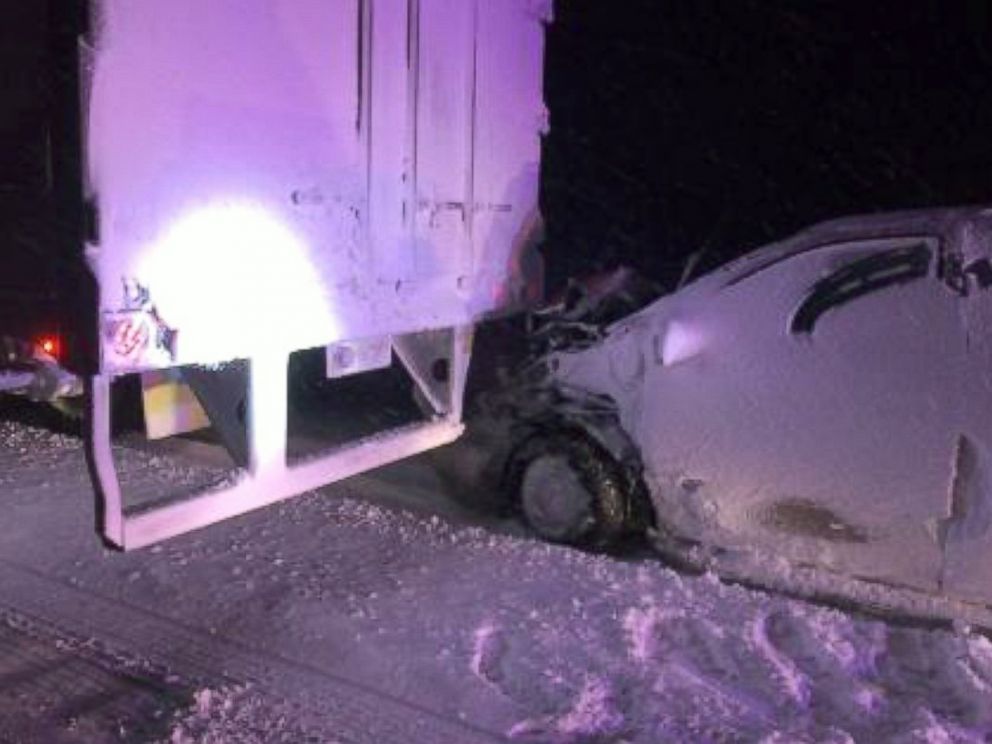 PHOTO: The minivan with a family inside became stuck under the back bumper of a truck.