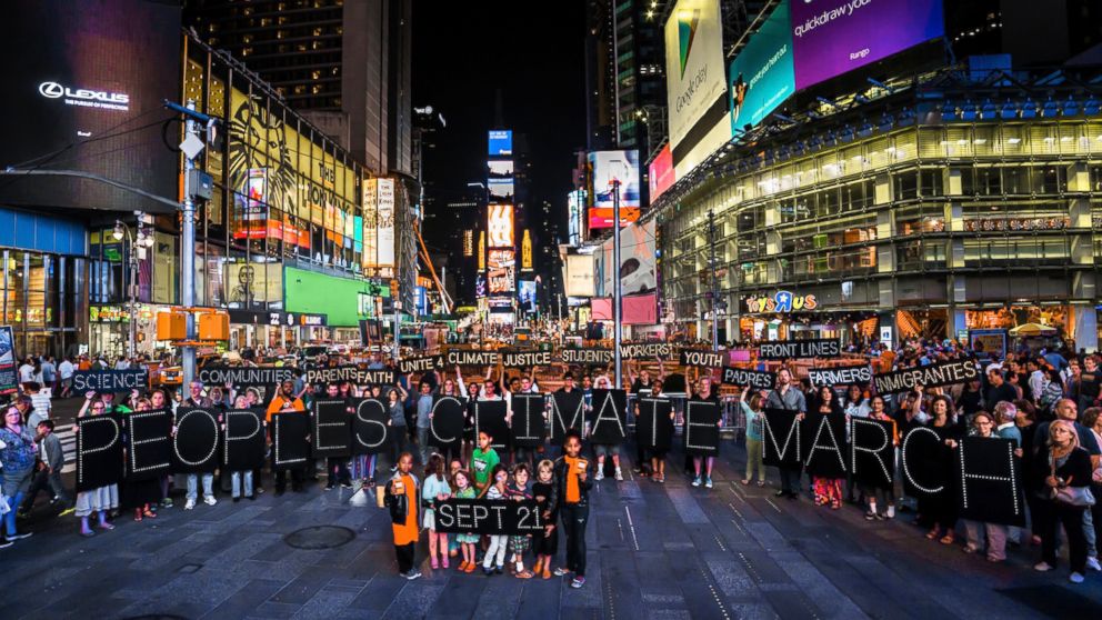 More than 30 people gathered in Times Square to promote the People's Climate March with illuminated signs on Aug. 28, 2014.