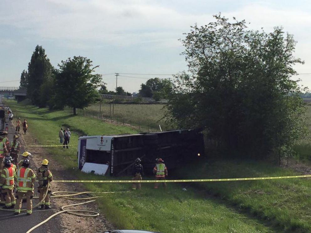 PHOTO: A shuttle bus rests on its side after a rollover crash Saturday morning, May 30, 2015, on Interstate 5 near the Butteville Road overpass.