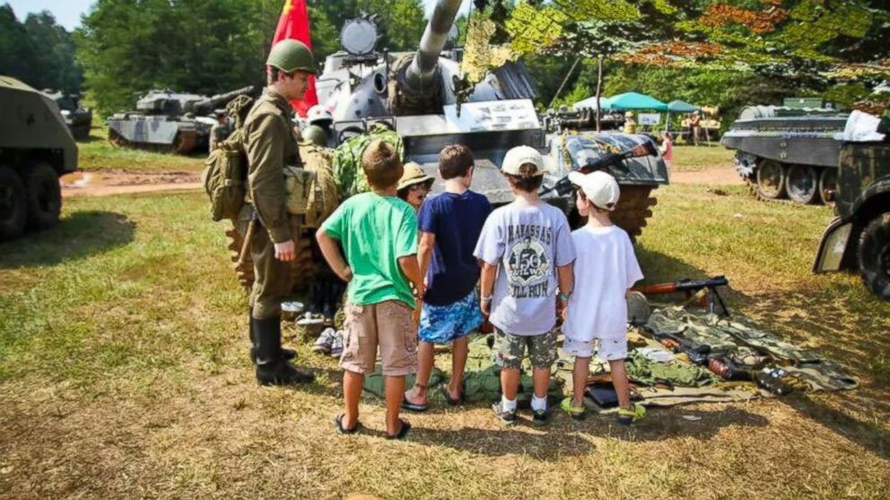 PHOTO: Kids check out the gear at a military simulation event in 2001 in Virginia.  