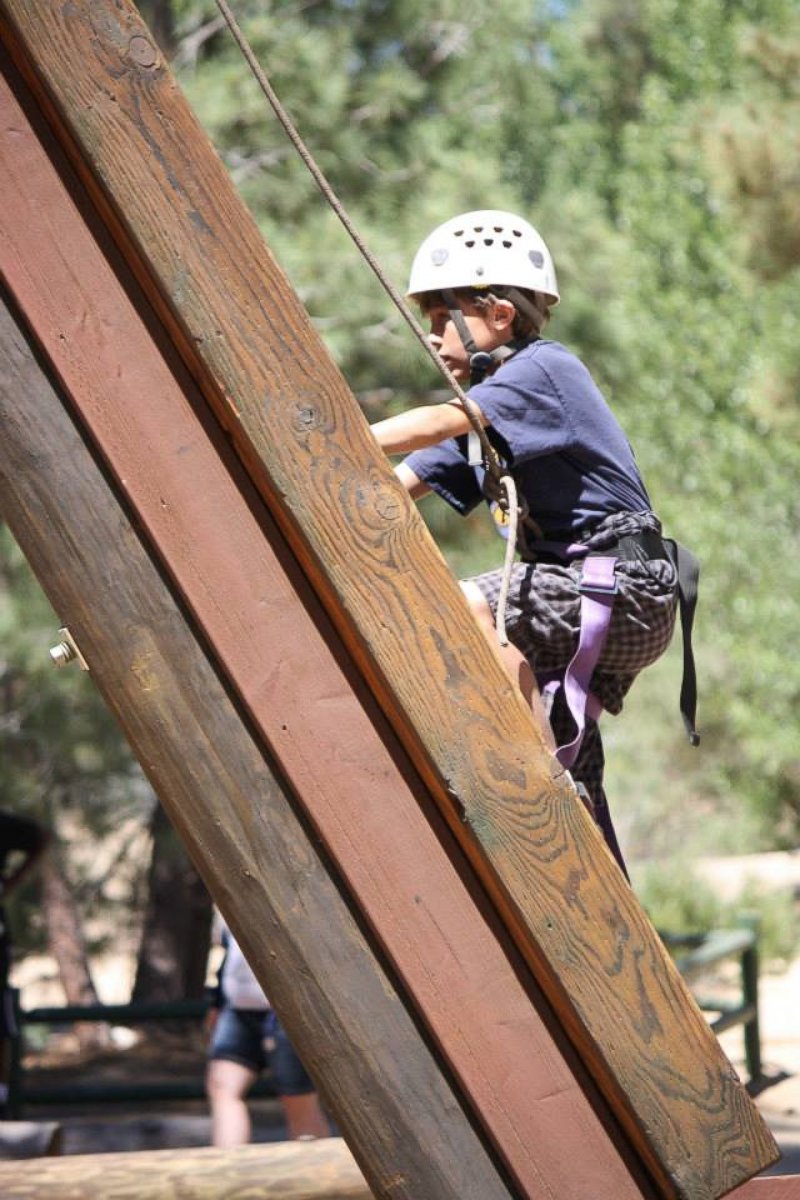 PHOTO:  A climber at Camp To Belong, which reconnects foster and adopted children with their siblings.  