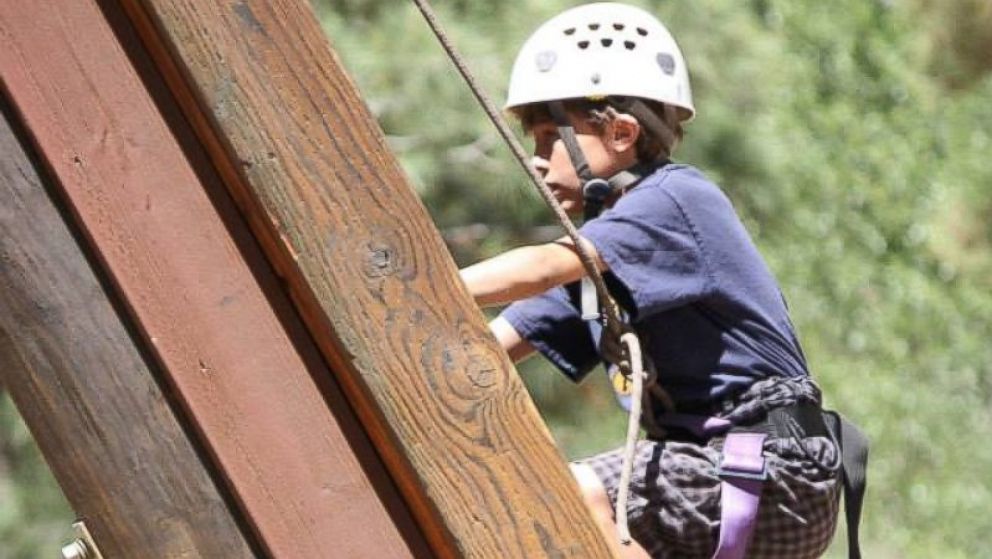 PHOTO:  A climber at Camp To Belong, which reconnects foster and adopted children with their siblings.  