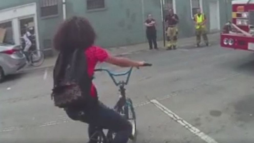 PHOTO:  A 15-year-old girl attempts to ride her bike away from police as they investigate a traffic accident in Hagerstown, Maryland.