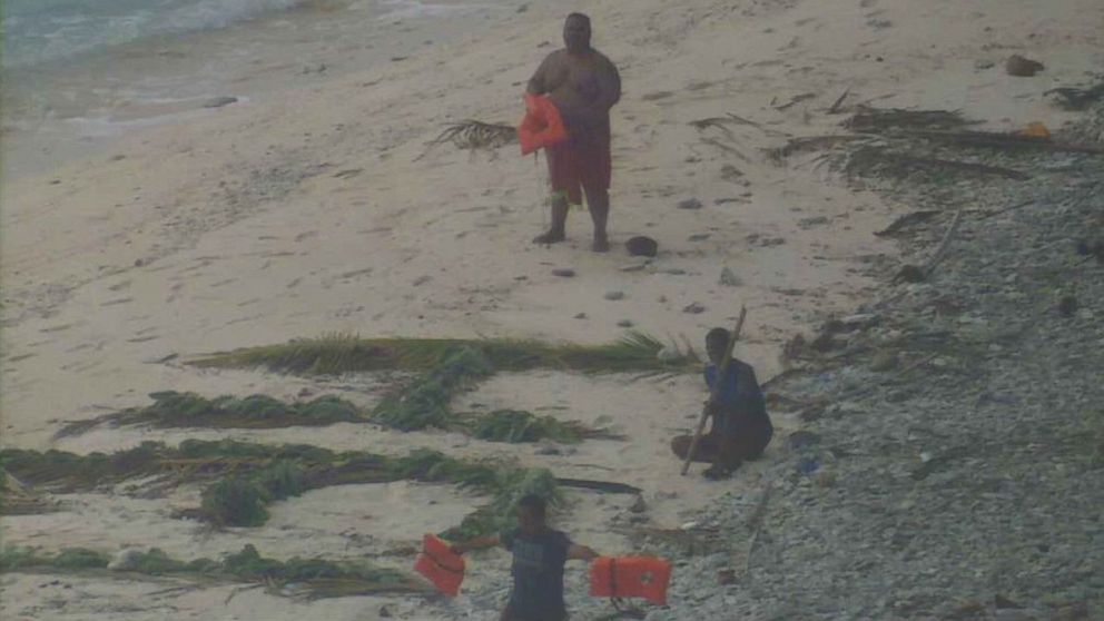 PHOTO: The crew aboard a U.S. Navy P-8A Poseidon maritime surveillance aircraft located three men who were waving life jackets near a large improvised "help" sign made of palm leaves on the uninhabited island of Fanadik, April 7, 2016.