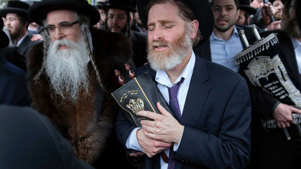 PHOTO: Community members, including Rabbi Chaim Rottenberg, left, celebrate the arrival of a new Torah near the rabbi's residence in Monsey, N.Y., Dec. 29, 2019. 