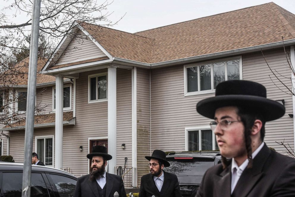 PHOTO: People gather in front of the house of Rabbi Chaim Rottenberg, Dec. 29, 2019, in Monsey, N.Y.