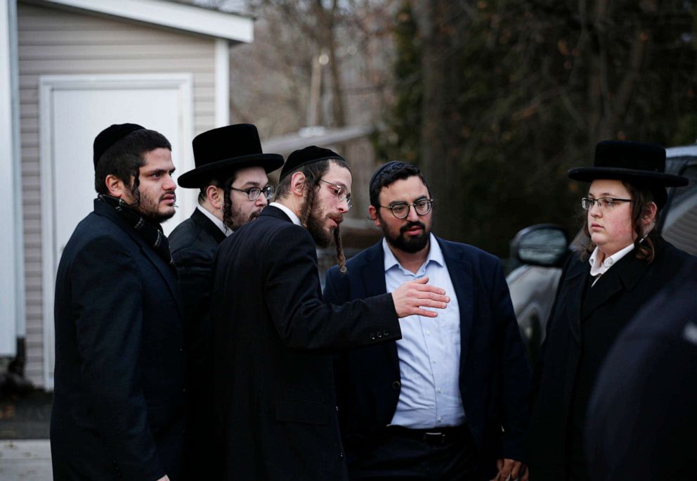 PHOTO: Members of the Jewish community gather outside the home of rabbi Chaim Rottenberg in Monsey, N.Y., Dec. 29, 2019, after an attack that took place earlier outside the rabbi's home during Hanukkah.