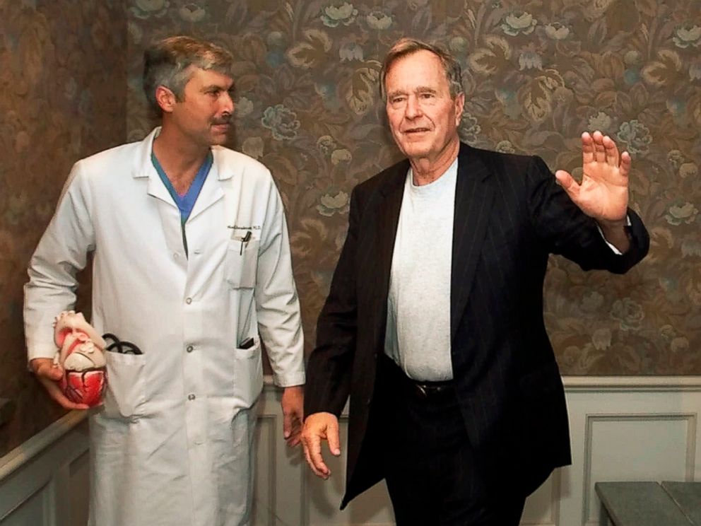 PHOTO: Former President George H.W. Bush waves as he leaves Methodist Hospital with his cardiologist, Mark Hausknecht, after a news conference in Houston.