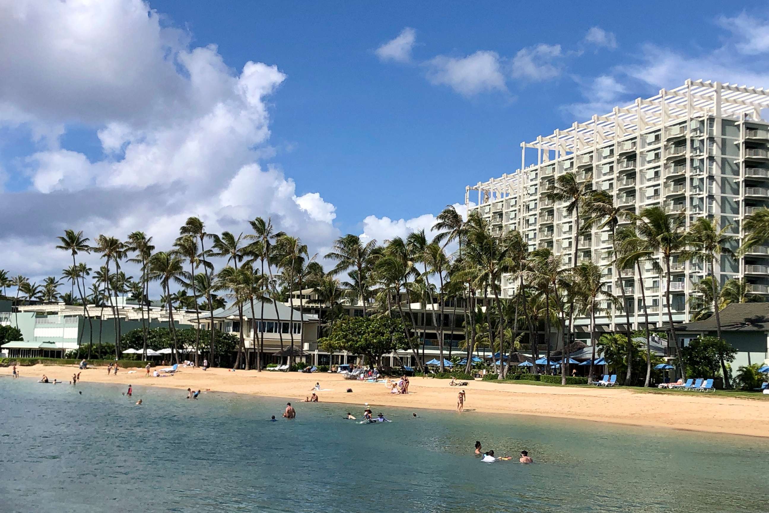 PHOTO: People are seen on the beach and in the water in front of the Kahala Hotel & Resort in Honolulu, Nov. 15, 2020. 