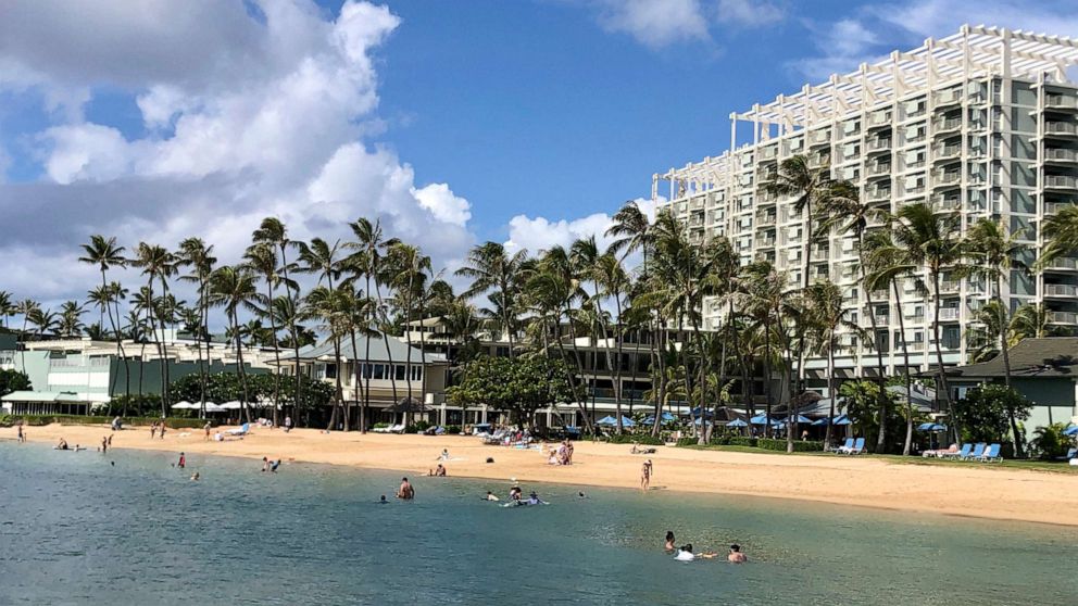 PHOTO: People are seen on the beach and in the water in front of the Kahala Hotel & Resort in Honolulu, Nov. 15, 2020. 