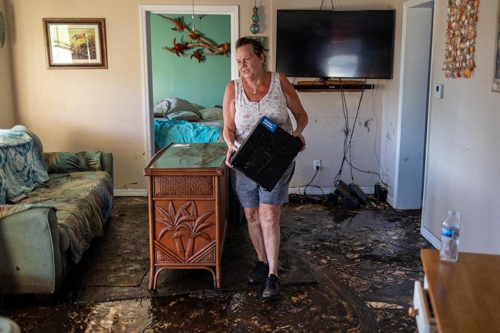 PHOTO: Melinda Segassie throws out electronics that had been ruined in the home where she lived with her husband Dani in the wake of Hurricane Helene in Steinhatchee, Florida, U.S., Sept. 29, 2024.   