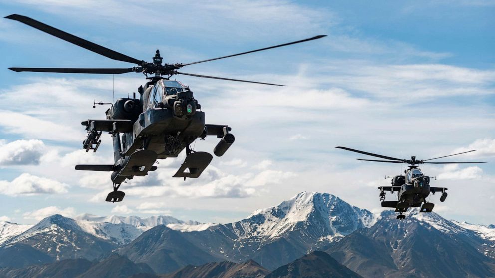 PHOTO: AH-64D Apache Longbow attack helicopters from the 1st Attack Battalion, 25th Aviation Regiment fly over a mountain range June 3, 2019 near Fort Wainwright, Alaska.