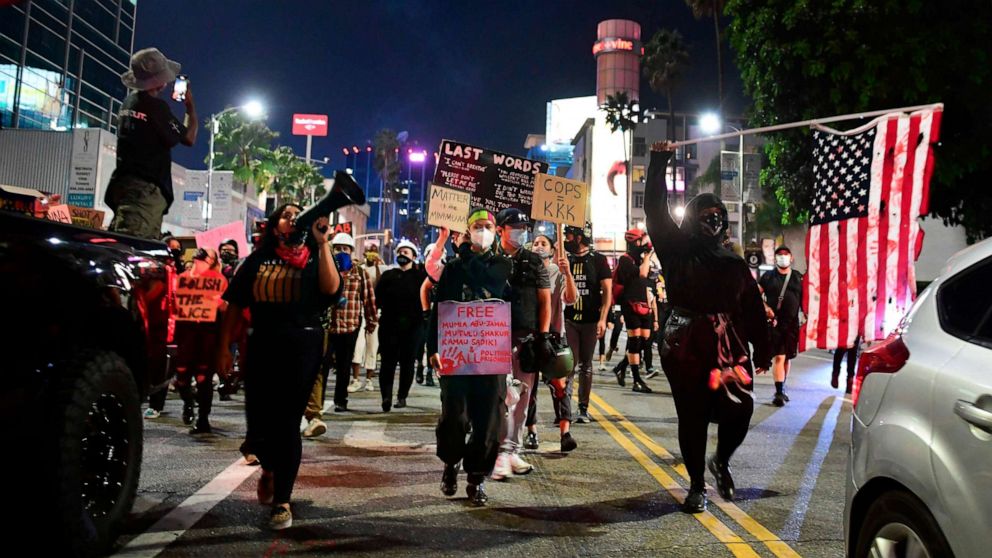 PHOTO: Demonstrators protesting the lack of criminal charges in the killing of Breonna Taylor by the Louisville Metropolitan Police Department, march along Sunset Boulevard in Hollywood, California on September 24, 2020.
