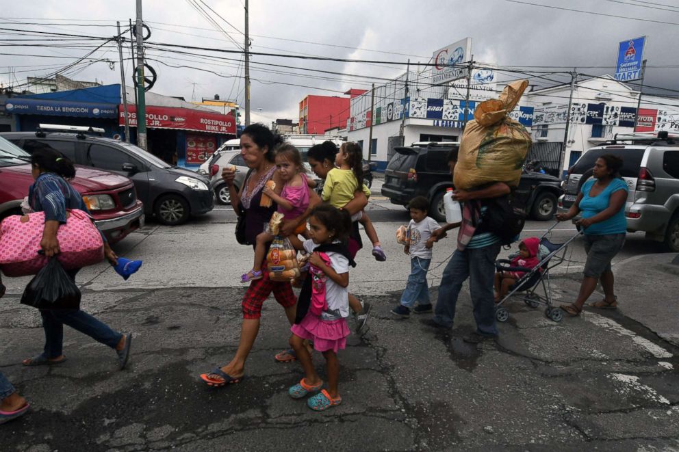 PHOTO: Honduran migrant families taking part in a caravan towards the United States, arrive in Guatemala City, Oct. 17, 2018.