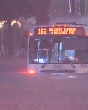 Passenger rescues a bus driver from their own bus after the bus was stuck in extreme rising floodwaters. Powerful storms dropped a half-foot of rain on Houston.