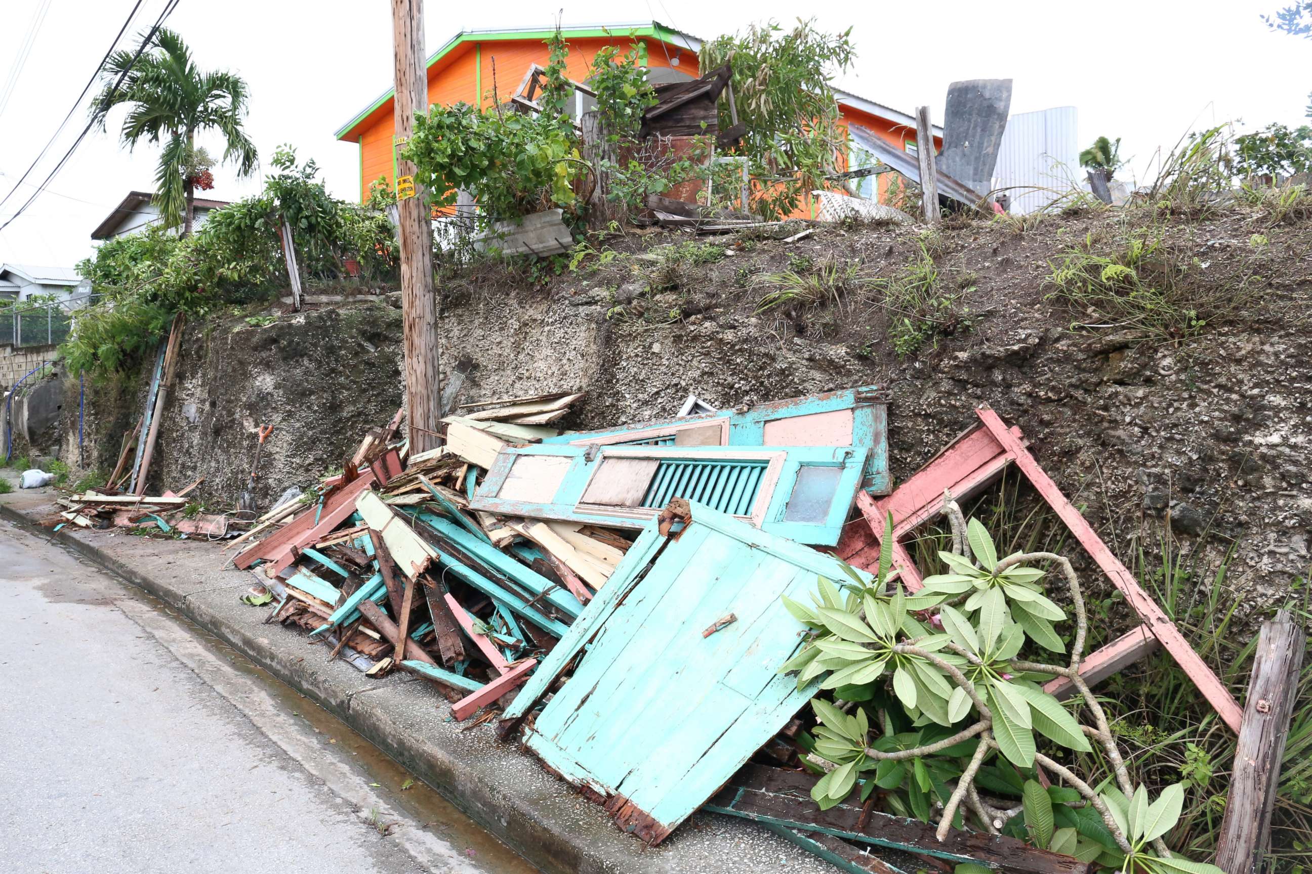PHOTO: Debris from a house lie next to a road after strong winds of Hurricane Elsa passed St. Michael, Barbados July 2, 2021.  REUTERS/Nigel Browne