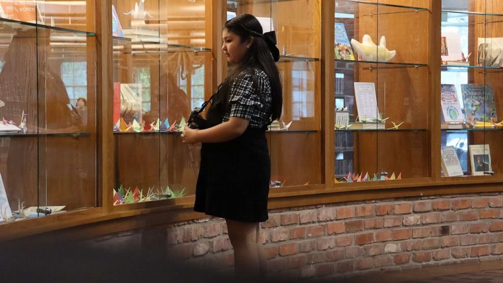 PHOTO: Madison is seen looking at a display of origami cranes at El Progreso Memorial Library in Uvalde, Texas, on Sept. 24, 2022.