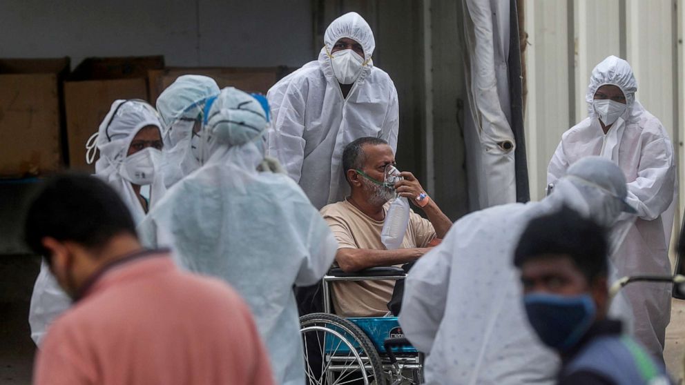 PHOTO: Health workers attend to a patient at the Jumbo COVID-19 field hospital in Mumbai, April 26, 2021.