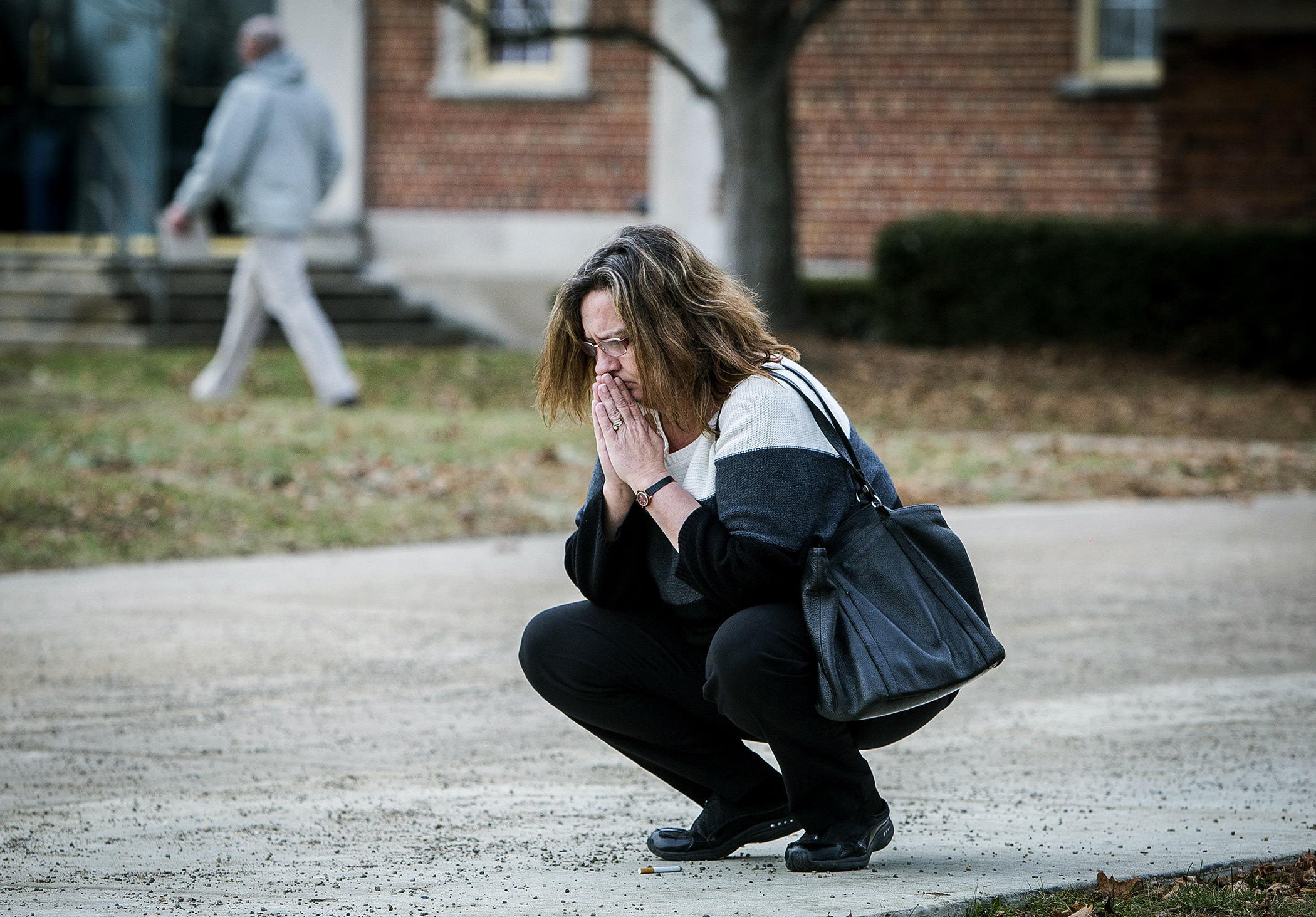 PHOTO: A parent prays outside of the Civic Hall Performing Arts Center before going inside to reunite with her child after a shooting occurred at Dennis Intermediate School, Thursday, Dec. 13 2018, in Richmond, Indiana.