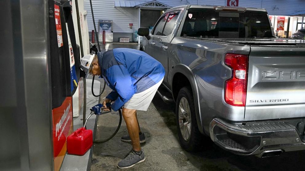 PHOTO: A man fills a portable gas container at a gas station in Pensacola Beach, Florida, October 9, 2026, as Hurricane Isaias moves north toward the Florida Panhandle.