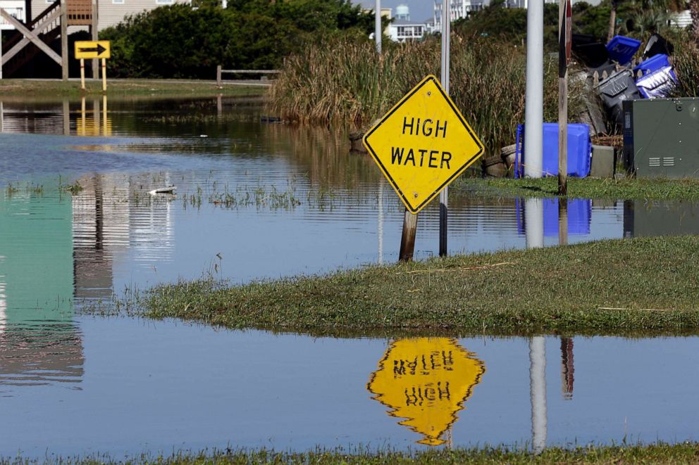 PHOTO: High water signs are posted along Ocean Drive following the effects of Hurricane Isaias in Caswell Beach, N.C., Aug. 4, 2020.