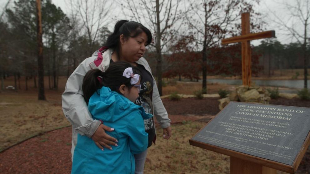 PHOTO: Cornelia JaRose Hollitoppa Bell, 7, visits a Covid memorial with aunt Mylindie Bell. She now lives with her aunt on the Choctaw Reservation in Mississippi.