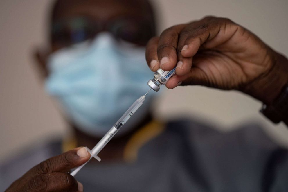 PHOTO: CORRECTS LOCATION   A health worker administers a dose of Janssen Johnson & Johnson COVID-19 vaccine at Dakar's Medina neighborhood, Senegal, Wednesday, July 28, 2021. 